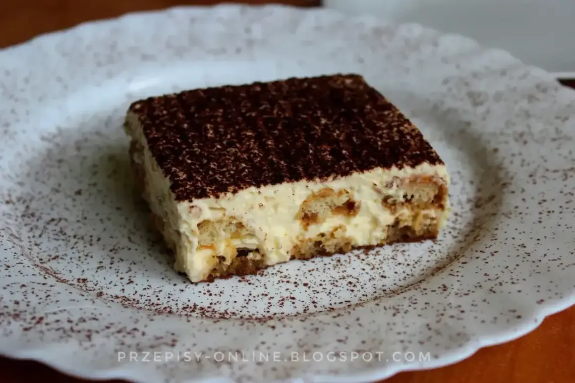 Pyszne tiramisu, czyli zabajone, na białym talerzu, posypane kakao.
