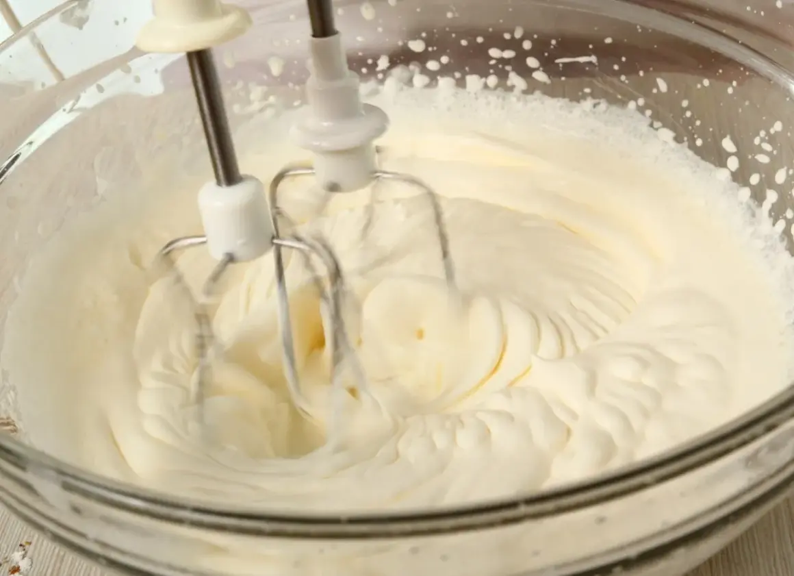 Ubity krem śmietankowy do tortu bez mascarpone, przygotowywany mikserem w szklanej misie. Idealna konsystencja na puszyste ciasto.